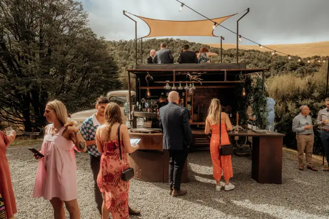 Wedding guests at the bar truck